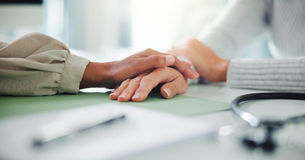 Doctor patient and hands with comfort for sympathy understanding or trust at clinic office Healthcare medical worker or client with touch for empathy breaking news or health support at hospital